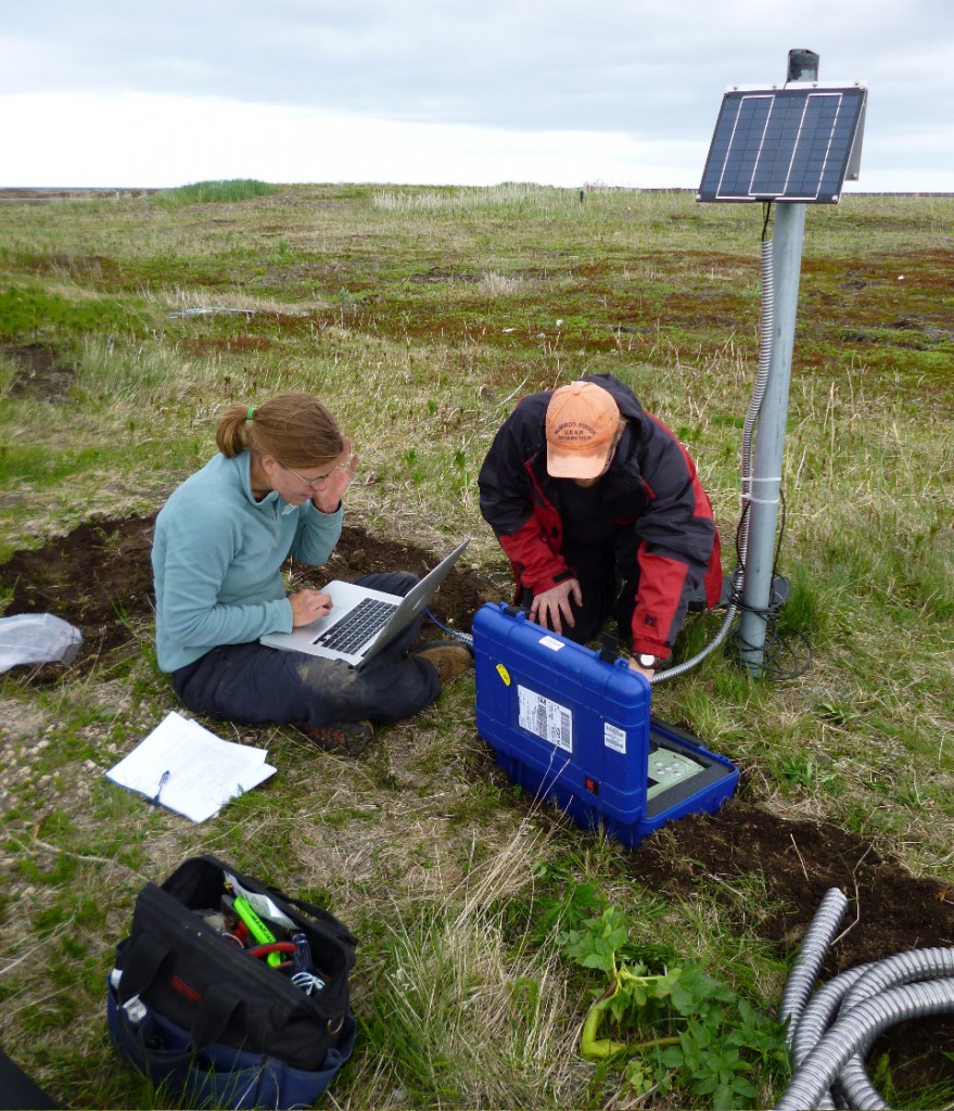 Figure 2. Katie Keranen and Guy Tytgat deploying a seismometer in Port Heiden