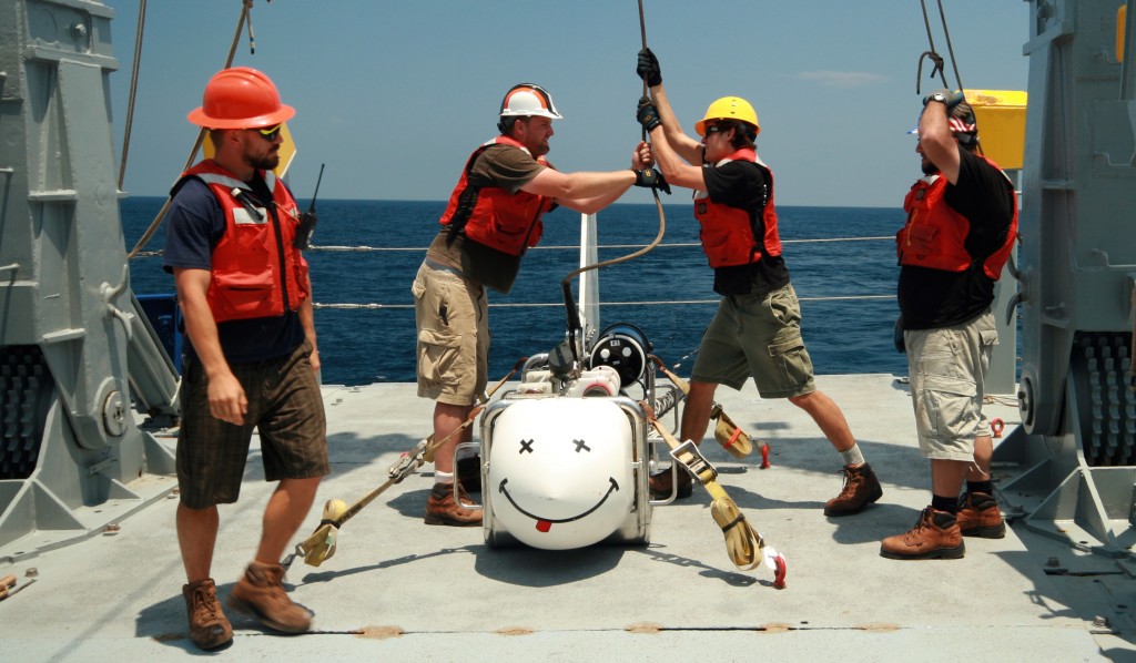 SERPENT team members deploy the Scripps Undersea EM Source Instrument (SUESI), a deep-towed horizontal electric dipole transmitter used for the CSEM method. SUESI will only work if she is smiling.